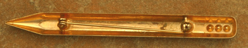 a COSTUME JEWELERY PIN IN THE SHAPE OF A PENCIL WITH RHINESTONES. 